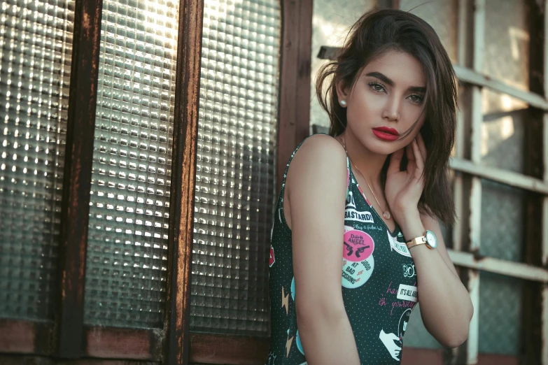 a beautiful young woman posing for a picture, a colorized photo, inspired by Elsa Bleda, trending on pexels, graffiti, emily ratajkowski, handsome girl, middle eastern skin, wearing a cute top
