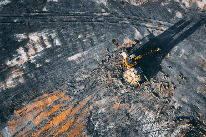 a bulldozer that is sitting in the dirt, by Adam Marczyński, unsplash contest winner, figuration libre, helicopter view, coal, “ iron bark, on the surface of an asteroid