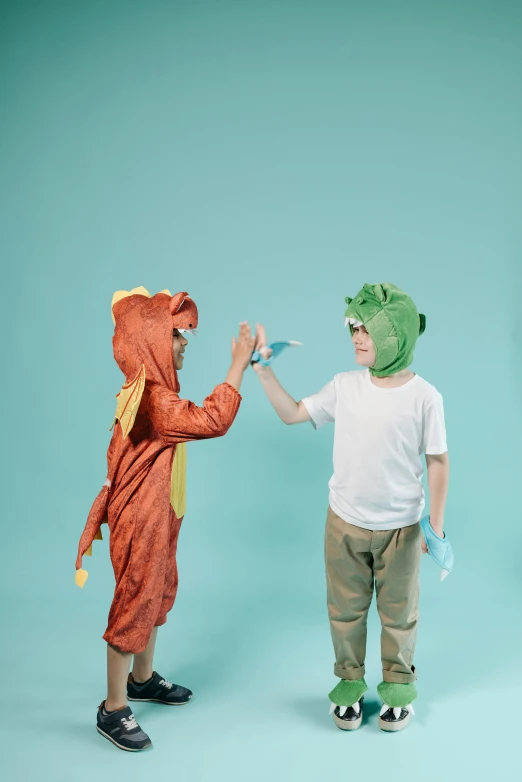 a couple of kids standing next to each other, pexels contest winner, conceptual art, wearing a dragon mask, dinosaur, playing games, wearing gloves