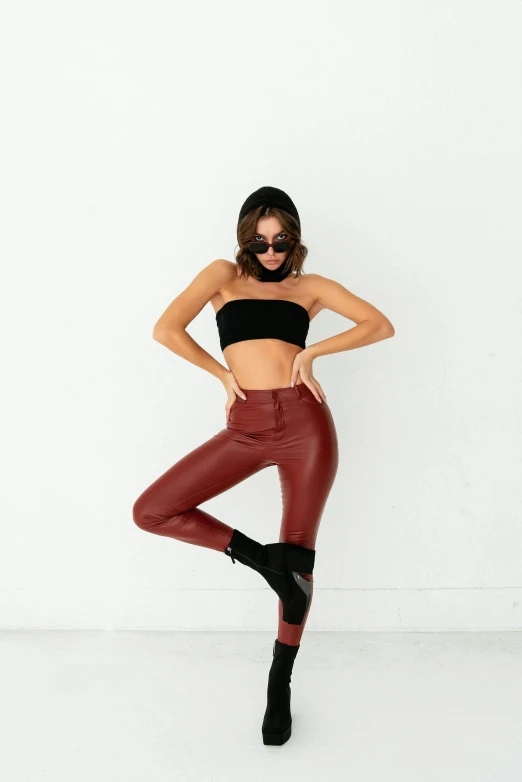 a woman in a black top and red leather pants, trending on pexels, arabesque, doing a sassy pose, panoramic, cut out, instagram photo