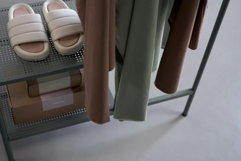 a rack with clothes and shoes on it, inspired by Francesco Furini, soft pads, taupe, detail shot, muted green