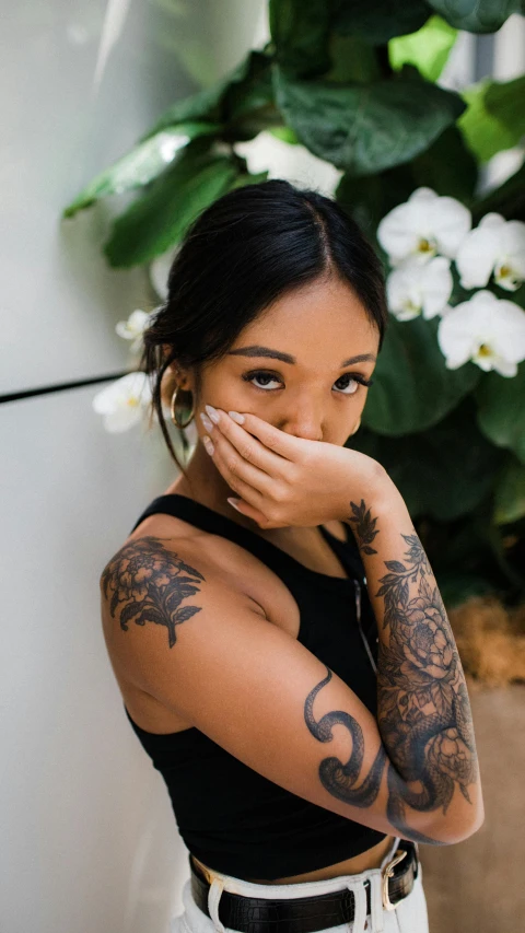 a woman with tattoos covering her face, inspired by Ruth Jên, trending on pexels, portrait of vanessa morgan, shrugging arms, mai anh tran, uploaded