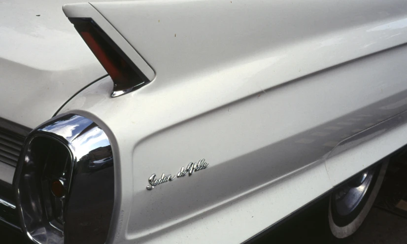 a close up of the rear end of a white car, by Stan Galli, 1 9 6 5 lightning, 1999 photograph, glossy white metal, swift