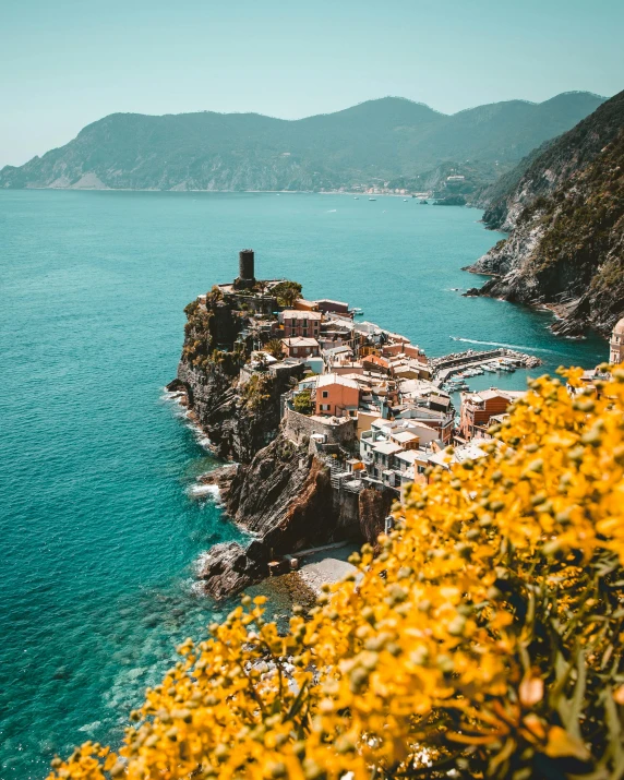 a small town sitting on top of a cliff next to the ocean, unsplash contest winner, renaissance, green and yellow colors, vouge italy, vibrant foliage, profile image