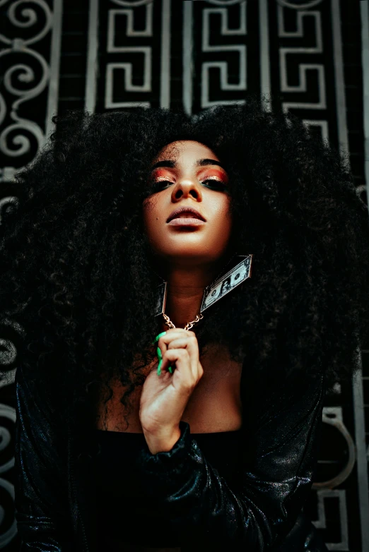 a woman with long curly hair holding a knife, an album cover, trending on pexels, afrofuturism, charli bowater, lush unkempt black hair, shot with sony alpha 1 camera, aida muluneh