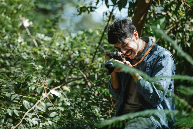 a man taking a picture of himself in the woods, pexels contest winner, sumatraism, mutahar laughing, avatar image, telephoto, close up portrait photo