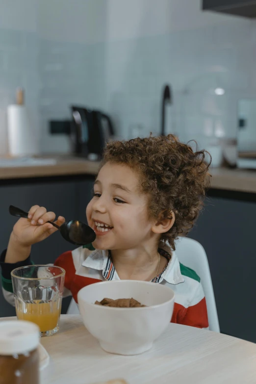 a couple of kids that are sitting at a table, pexels contest winner, cereal, happy chef, girl with brown hair, black