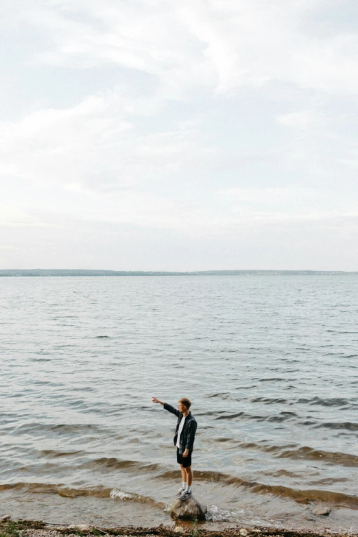 a person standing in a body of water, by Carey Morris, unsplash, waving, helsinki, plain background, lake house