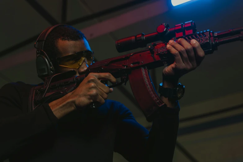 a close up of a person holding a rifle, led gaming, everyone having fun, red and blue lighting, tournament