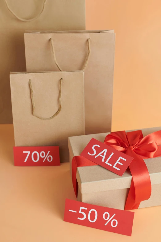 a couple of bags sitting on top of a table, a stock photo, shutterstock, images on the sales website, brown paper, ribbon, 1970'