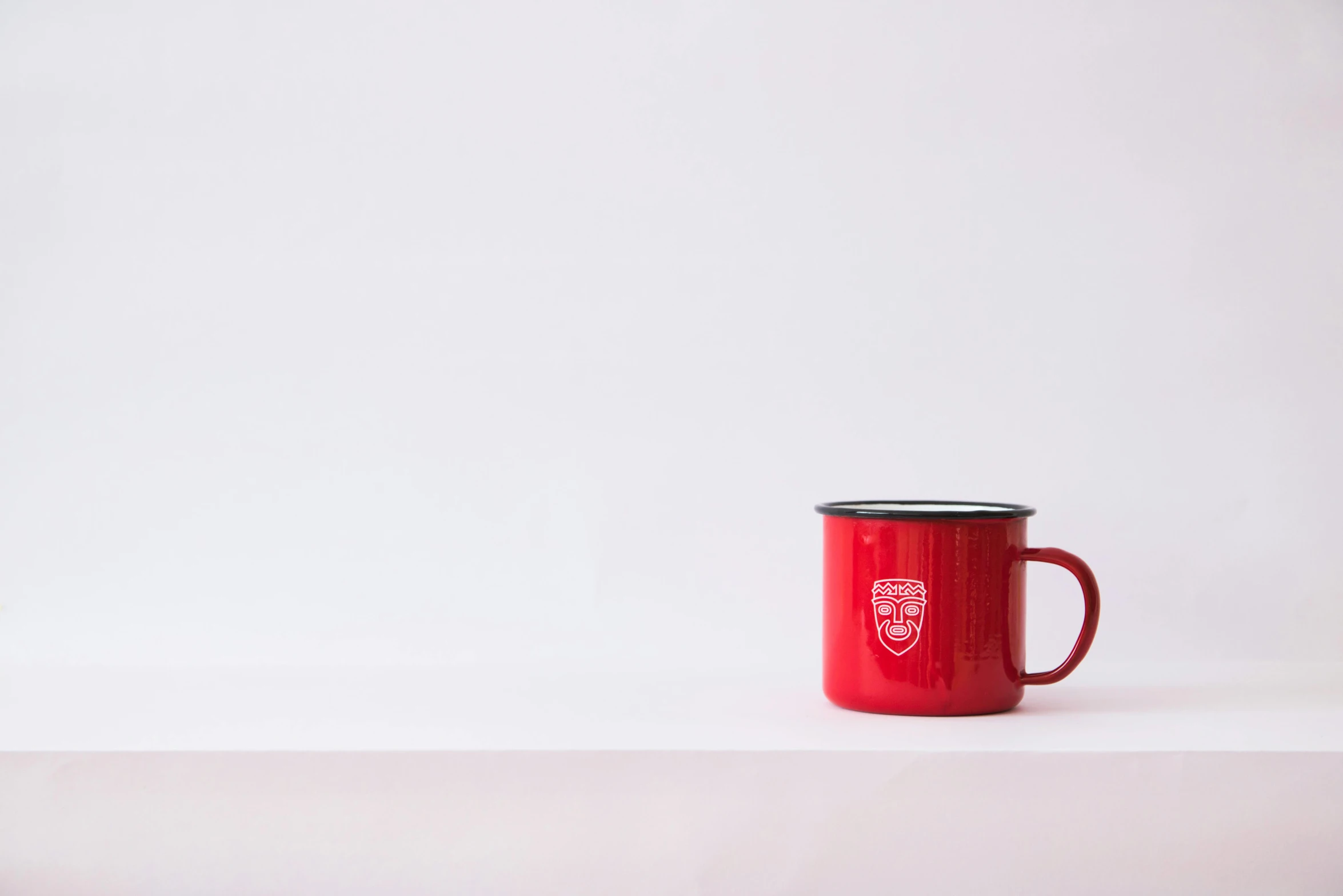 a red mug sitting on top of a white table, by Niels Lergaard, unsplash, enamel, highly detailed product photo, duff beer, front view