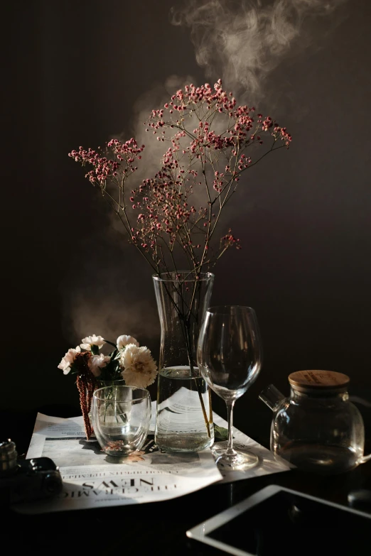 a vase filled with flowers sitting on top of a table, a still life, trending on unsplash, romanticism, very smoky paris bar, glassware, late autumn, with smoke