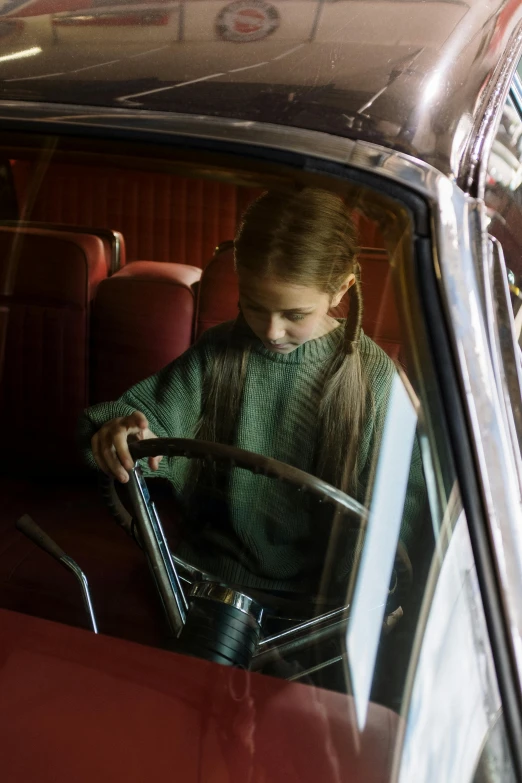 a little girl sitting in the driver's seat of a car, by David Donaldson, mackenzie foy, seventies cinestill, prizewinning, julia hetta