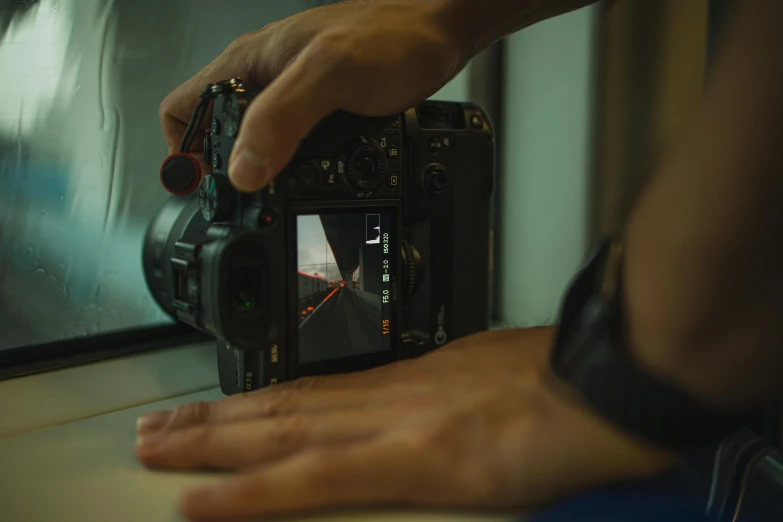 a close up of a person holding a camera, a picture, behind the scenes, cinematic post-processing, digital artist, b - roll