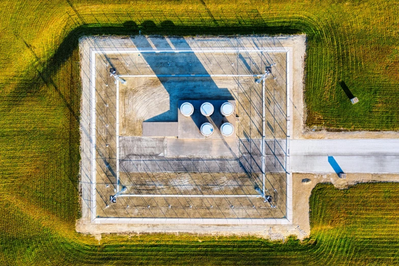 an aerial view of a building in the middle of a field, by Daniel Lieske, unsplash contest winner, conceptual art, metal towers and sewers, square, iowa, thumbnail