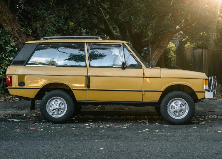 a yellow car parked on the side of the road, a portrait, unsplash, renaissance, 1981 photograph, gold body, bulli, well preserved