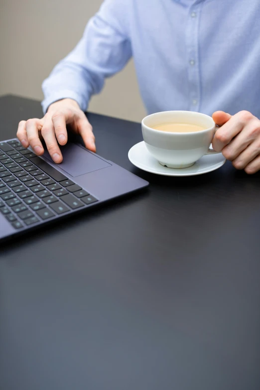 a man sitting at a table with a laptop and a cup of coffee, digital image, no - text no - logo, premium, keyboard