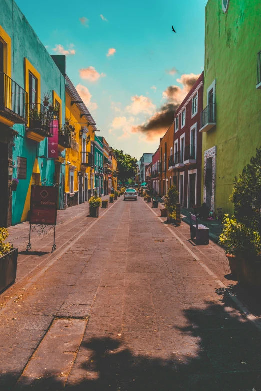 a street filled with lots of colorful buildings, a colorized photo, pexels contest winner, mexican, green and yellow colors, square, empty streets