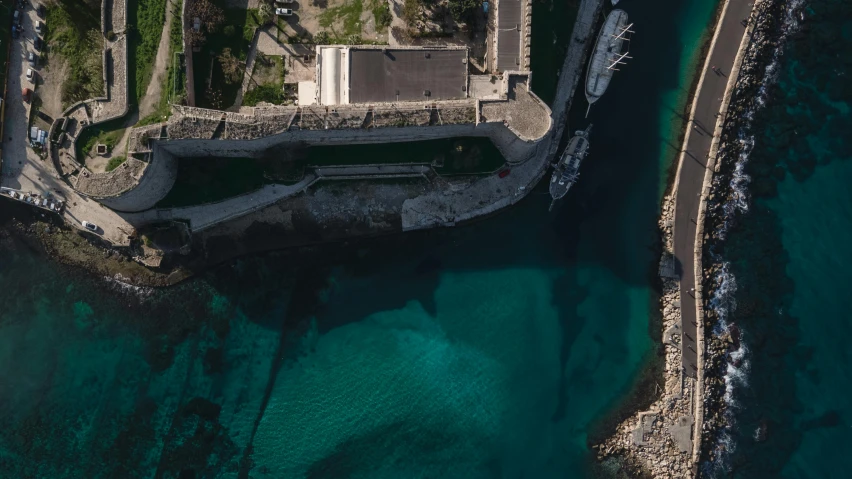 an aerial view of a building next to a body of water, pexels contest winner, les nabis, cyprus, navy, thumbnail, harbour