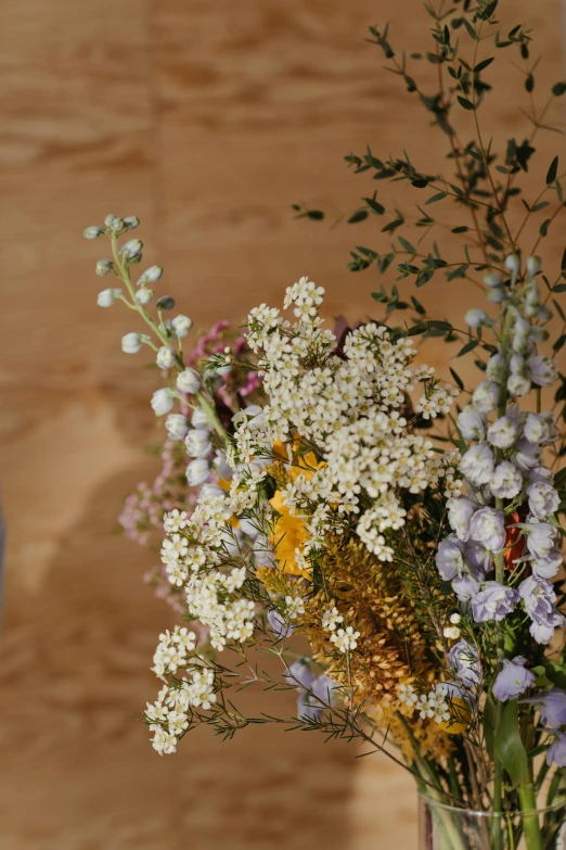 a vase filled with flowers sitting on top of a table, natural muted tones, made of wildflowers, slide show, large tall