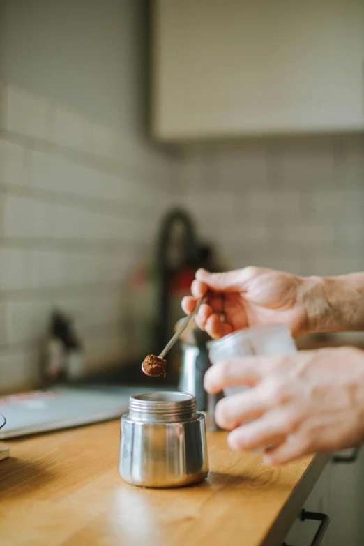 a close up of a person preparing food in a kitchen, pexels contest winner, hot coffee, salt shaker, gif, spoon placed