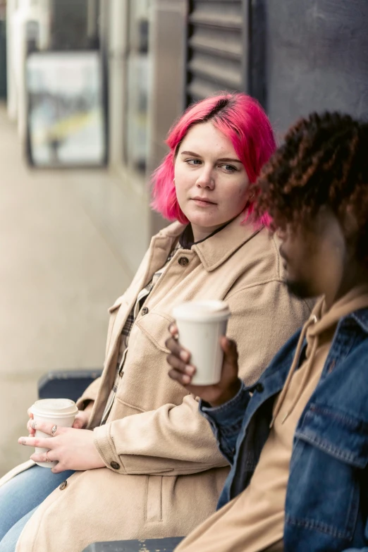 a couple of women sitting next to each other on a bench, inspired by Elsa Bleda, trending on pexels, realism, with pink hair, cup of coffee, people waiting in bus stop, juno promotional image