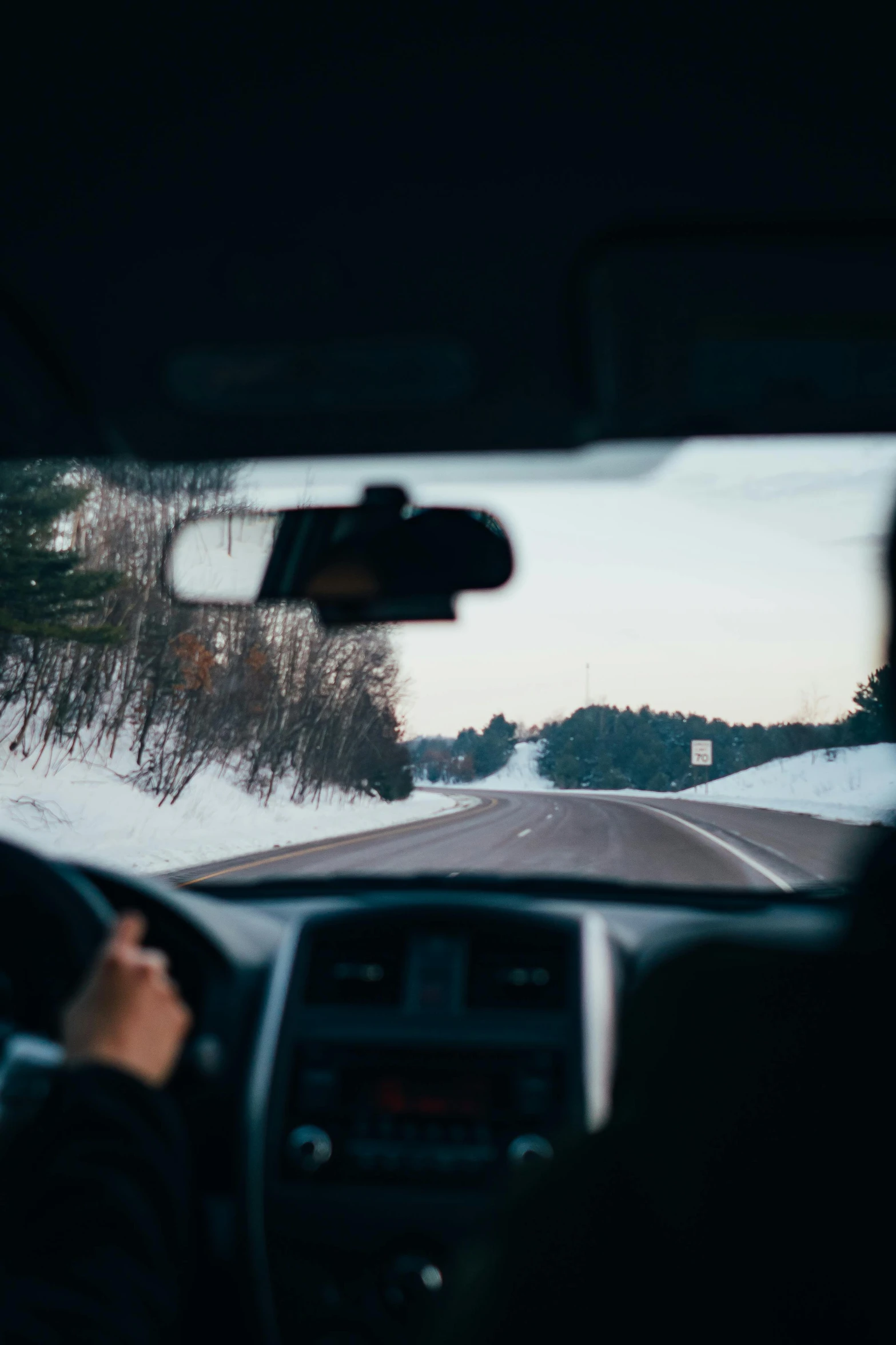 a person driving a car on a snowy road, looking from behind, 🚿🗝📝, portrait featured on unsplash, simple nostalgic