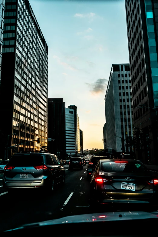 a street filled with lots of traffic next to tall buildings, unsplash, los angeles 2 0 1 5, square, late summer evening, vehicle