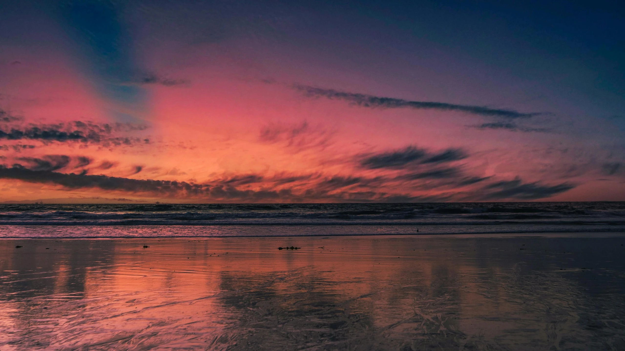 a colorful sunset is reflected in the wet sand, by Andrew Allan, pexels contest winner, pink, panoramic photography, oceanside, crimson clouds