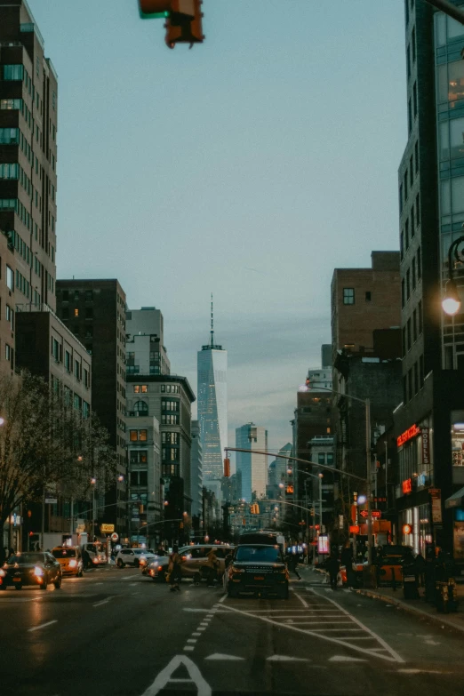 a street filled with lots of traffic next to tall buildings, trending on unsplash, modernism, new york back street, beautiful low light, low quality photo, city of industry