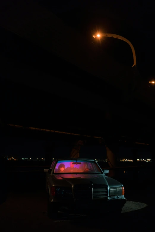 a car parked in a parking lot at night, an album cover, by Steve Brodner, ap art, police lights, cinematic shot ar 9:16 -n 6 -g, overpass