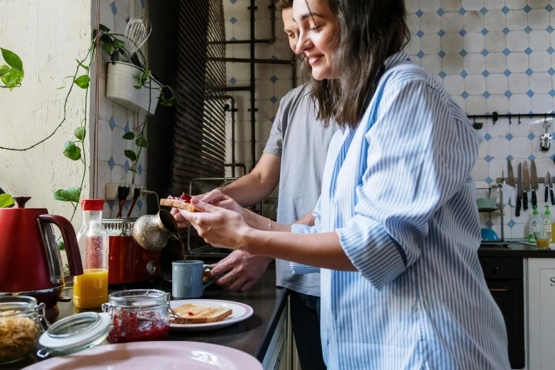 a woman standing in a kitchen preparing food, by Alice Mason, pexels contest winner, wearing pajamas, avatar image, al fresco, breakfast
