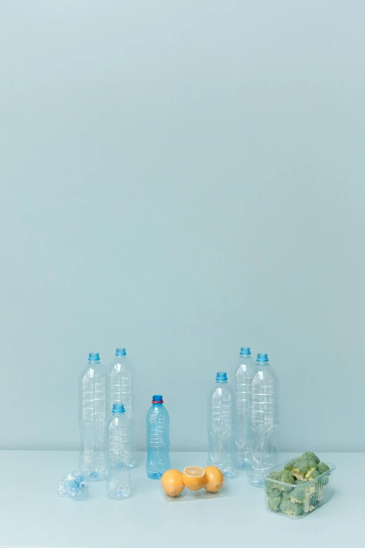 a bunch of plastic bottles sitting on top of a table, by Maeda Masao, unsplash, plasticien, minimalist photorealist, light-blue, picnic, made of water