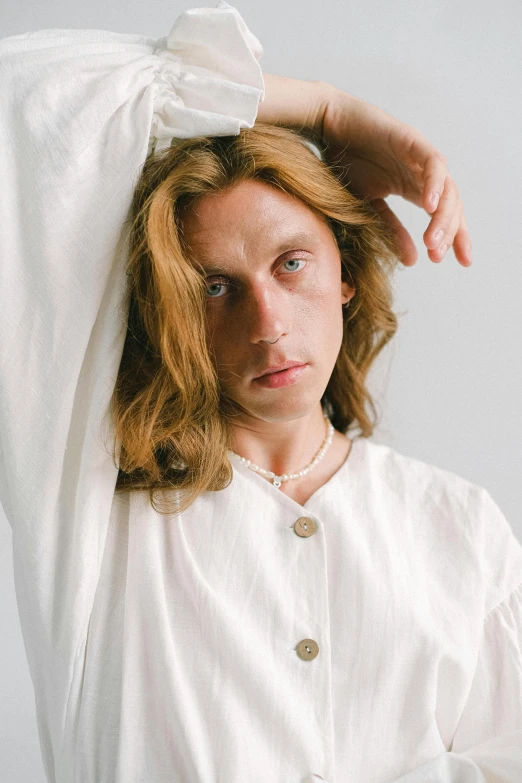 a woman in a white shirt with a bow on her head, an album cover, inspired by Lasar Segall, trending on unsplash, renaissance, portrait of young man, wearing white pajamas, androgynous person, looking to camera