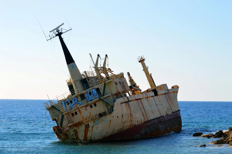 a rusted ship in the middle of the ocean, building crumbling, striking pose, getty images, cyprus