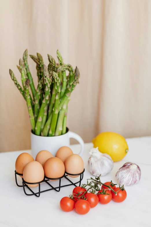 a white table topped with eggs and asparagus, a still life, unsplash, detailed product image, fruit basket, large tall, indoor shot