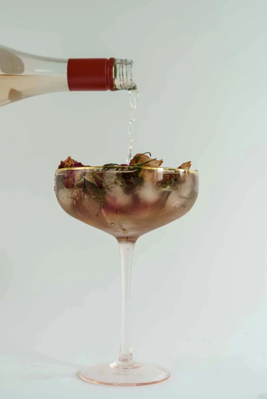 a person pouring wine into a wine glass, inspired by Carlo Martini, large rose petals, hegre, gilded. floral, edge to edge