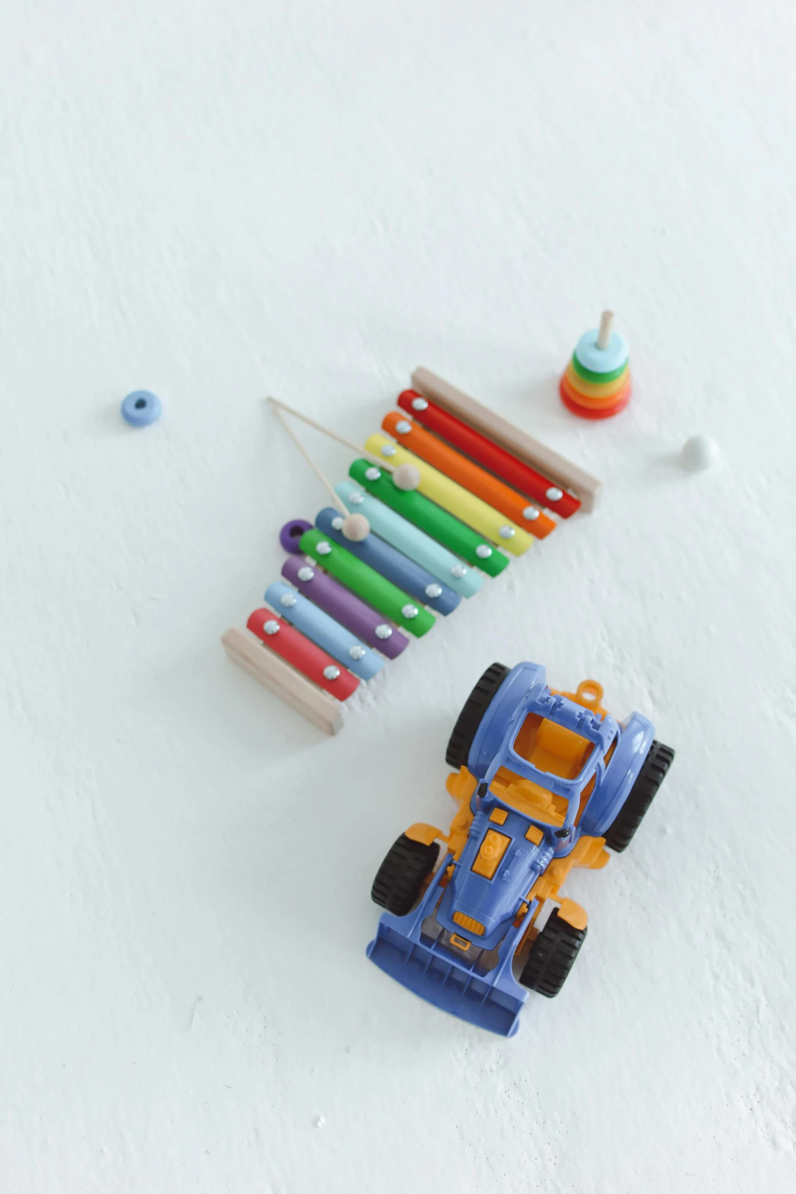 a toy car sitting on top of a snow covered ground, crayon art, xylophone, muted multi-color lapis, high angle shot, detailed product image