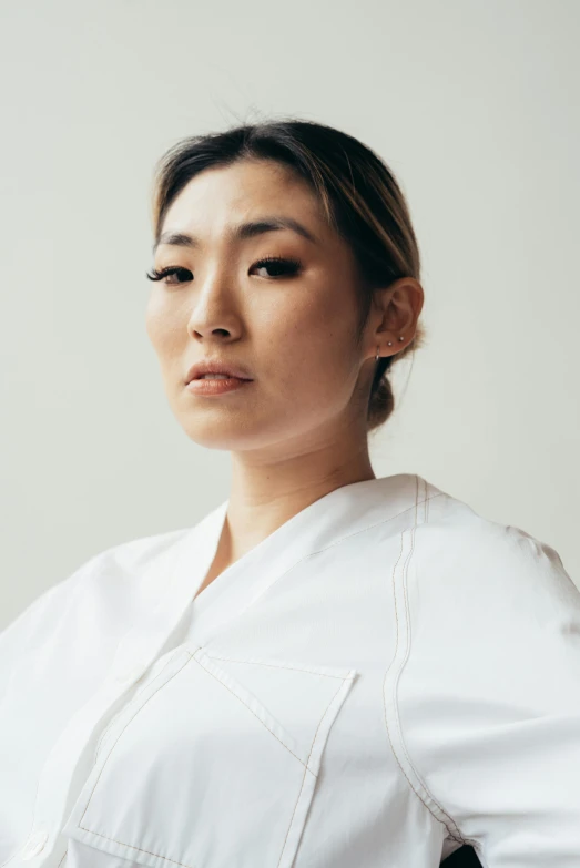 a woman in a white shirt posing for a picture, inspired by Sawa Sekkyō, surgeon, looking away from the camera, jen yoon, ethnicity : japanese