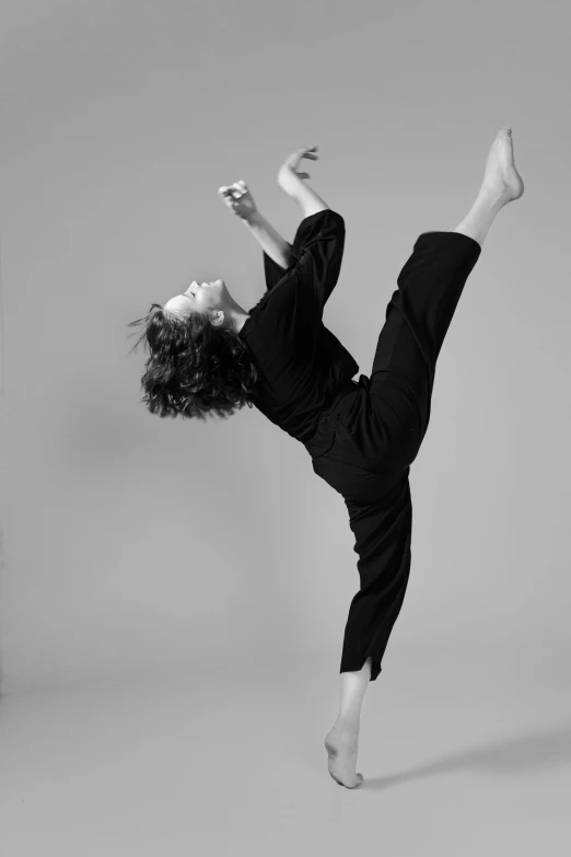 a black and white photo of a woman doing a handstand, arabesque, simon birch, posing for a fight intricate, tai chi, max dennison