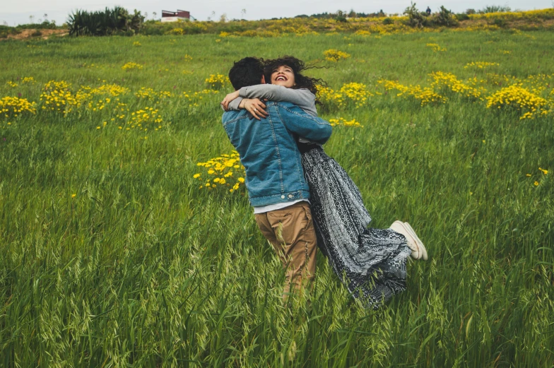 a couple hugging in a field of tall grass, by Lucia Peka, pexels contest winner, happening, playful, promo image, in a open green field, flowers around