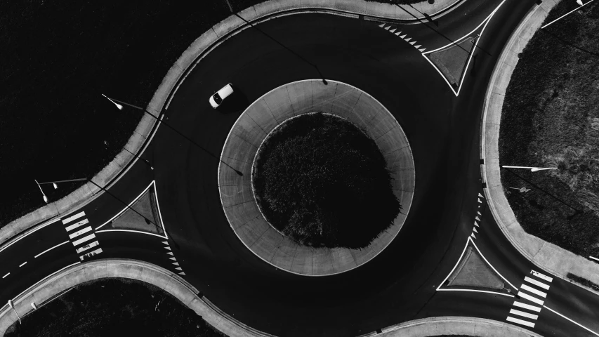 a black and white photo of an intersection, by Adam Rex, unsplash contest winner, conceptual art, black round hole, drone photograpghy, car, swirly