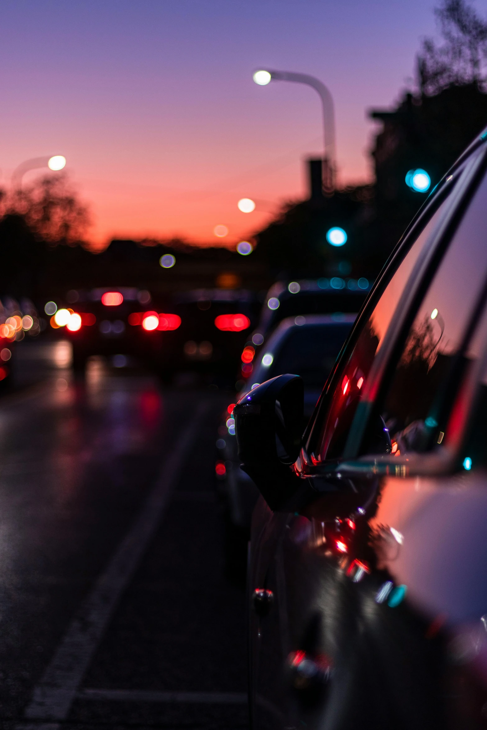 a city street filled with lots of traffic at night, by Niko Henrichon, looking out at a sunset, morning detail, car, side