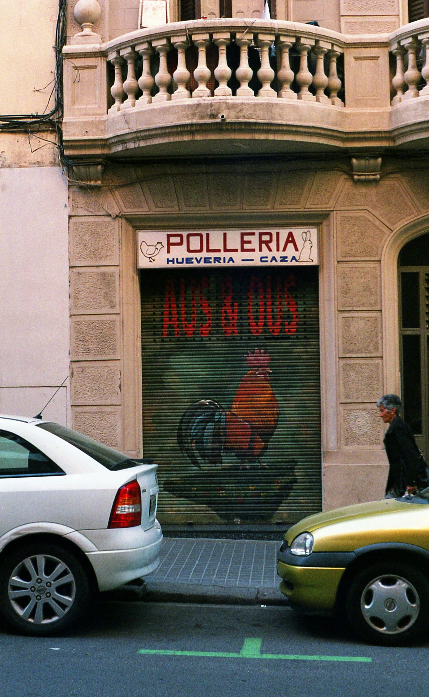 a couple of cars parked in front of a building, by Luis Molinari, illustration of an angry rooster, low quality photo, old signs, polychaeta