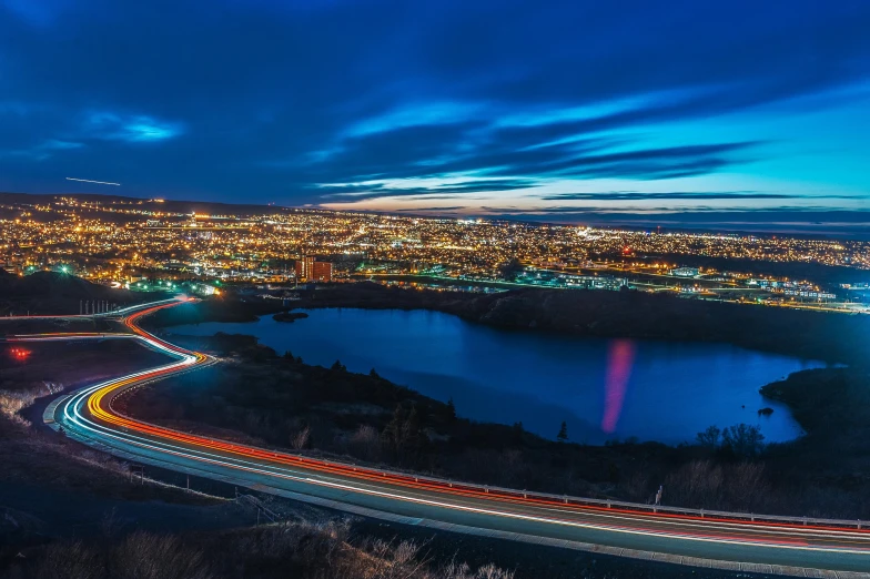 a view of a city at night from the top of a hill, by Matt Cavotta, pexels contest winner, yeg, blue and red lights, paisley, slide show