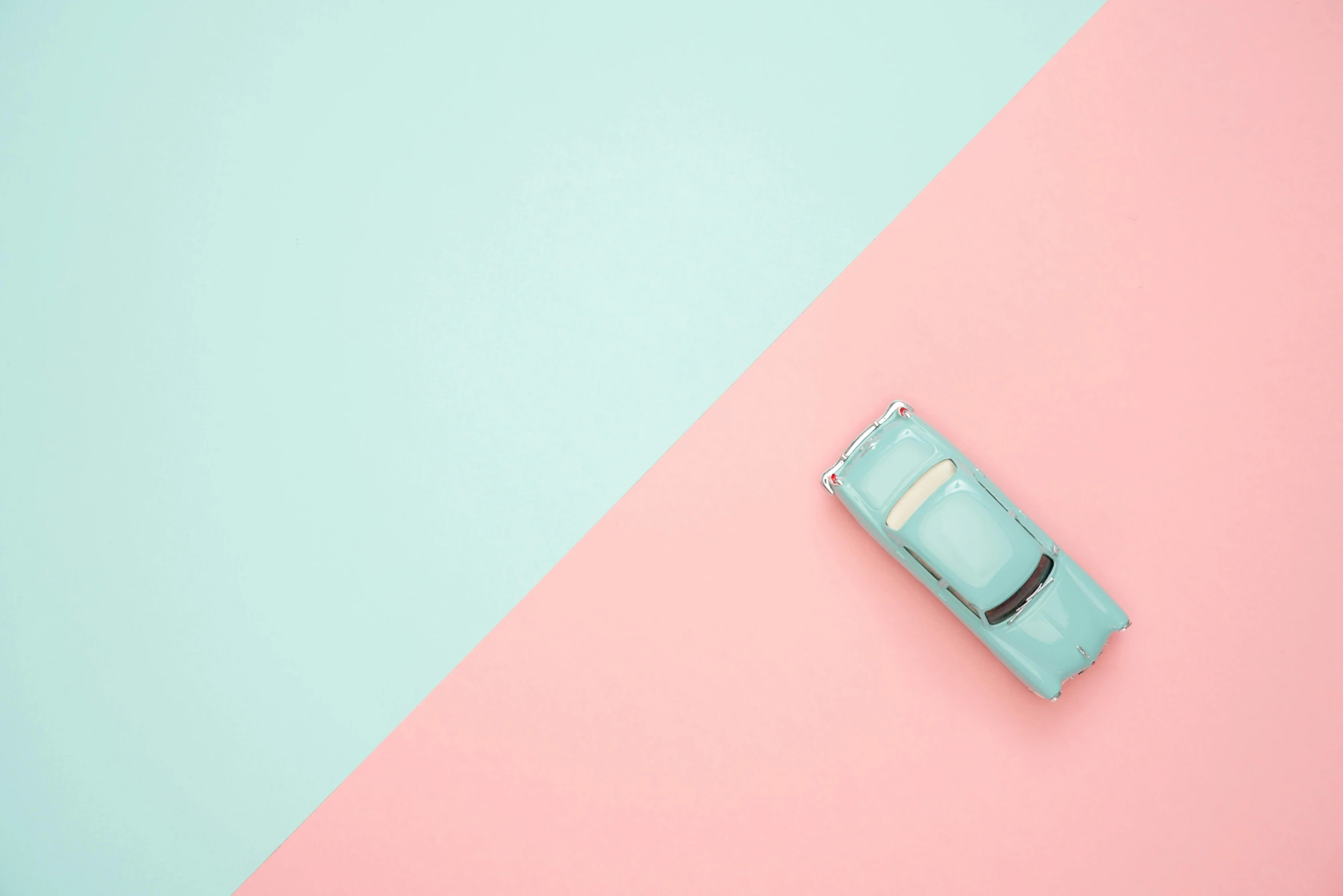 a toy car sitting on top of a pink and blue background, trending on unsplash, postminimalism, pastel green, from above, 6 0 s colour palette, elegant minimalism