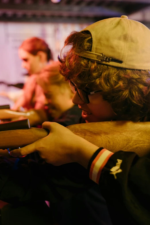 a man that is holding a gun in his hand, an album cover, featured on reddit, twins playing video games, candid portrait photo, student, tournament