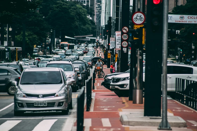 a street filled with lots of traffic next to tall buildings, by Matt Stewart, pexels contest winner, sao paulo, 🚿🗝📝