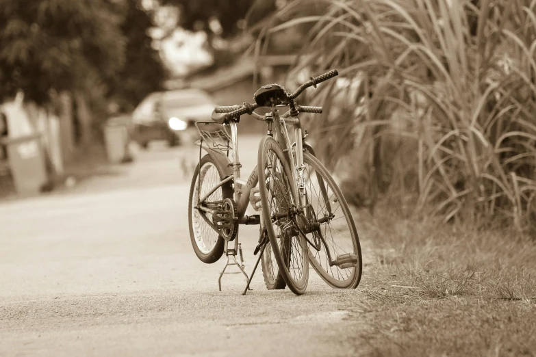 a bicycle parked on the side of a road, sepia photography, best friends, medium - shot, recreation