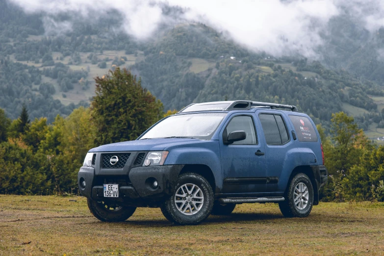 a blue truck parked in a field with mountains in the background, a portrait, unsplash, square, chilean, with a roof rack, 8 k octane comprehensive render